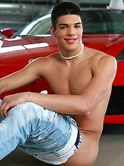 Glamorous and sexy jock posing near red Ferrari