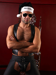 Dirty santa with hairy chest posing in leather dress