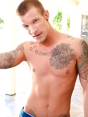 Tattooed dude plays with his hard cock